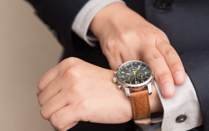 Businessman checking the time on his wrist watch